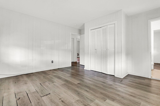 unfurnished bedroom with hardwood / wood-style floors