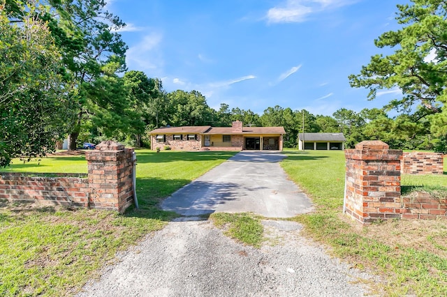 view of front of property with a front yard and a carport