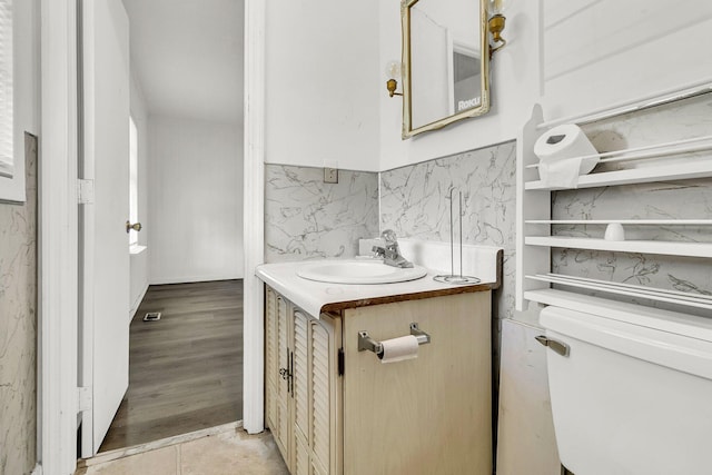 bathroom with vanity, tile patterned floors, and toilet