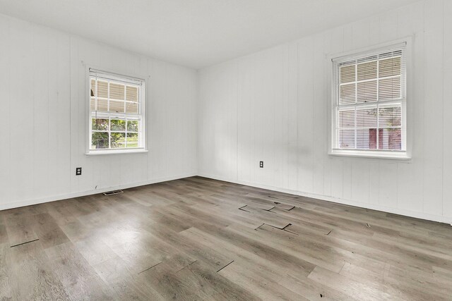 empty room with hardwood / wood-style flooring