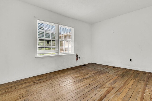 unfurnished room featuring wood-type flooring