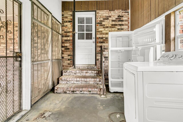 washroom with washer / dryer and wooden walls