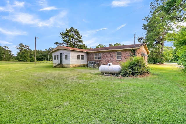 rear view of house with a yard