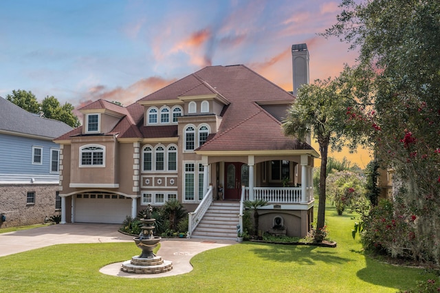 view of front of property with a lawn and a garage