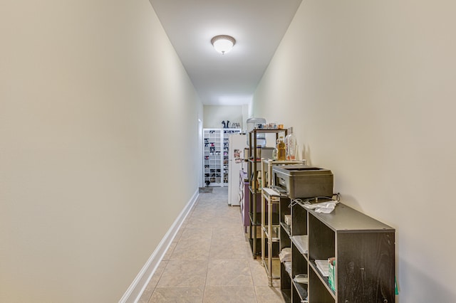 hall featuring light tile patterned floors