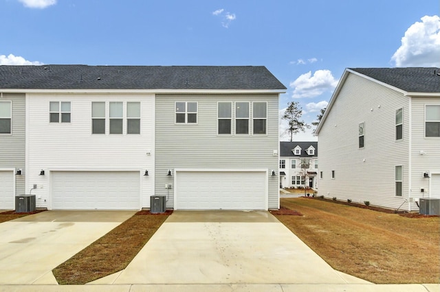 view of front facade with a garage and central AC unit