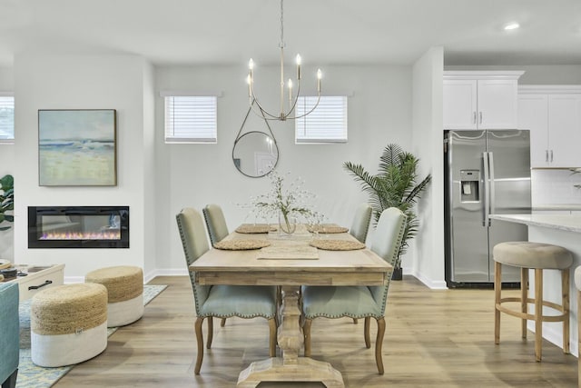 dining room with a notable chandelier and light hardwood / wood-style floors