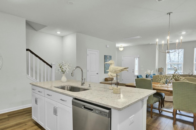 kitchen with sink, white cabinetry, a center island with sink, stainless steel dishwasher, and pendant lighting