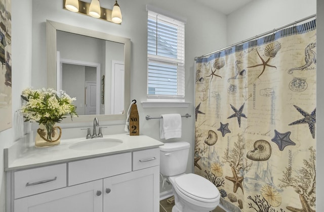 bathroom with vanity, toilet, and a shower with shower curtain