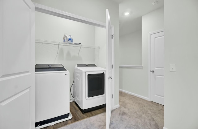 laundry area with washing machine and dryer and carpet flooring