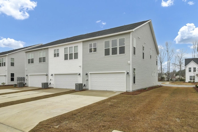 exterior space with a garage and central air condition unit