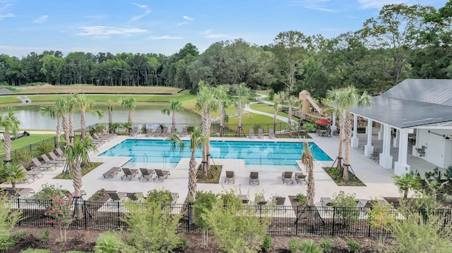 view of pool featuring a water view and a patio area