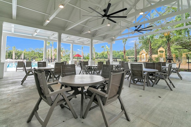 exterior space featuring a fenced in pool and ceiling fan