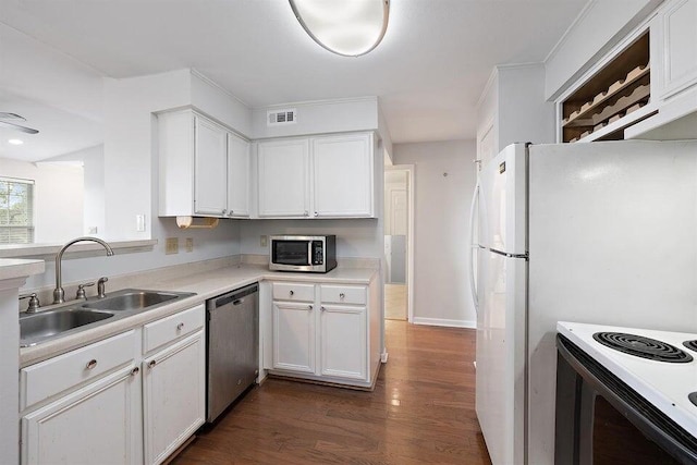 700 Daniel Ellis Dr Unit 11302, Charleston, SC 29412 - kitchen featuring stainless steel appliances, a sink, white cabinets, light countertops, and dark wood-type flooring