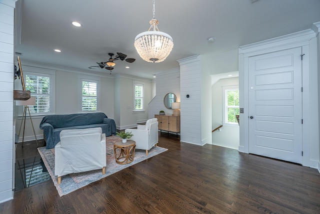living area with wood finished floors, a chandelier, crown molding, baseboards, and recessed lighting
