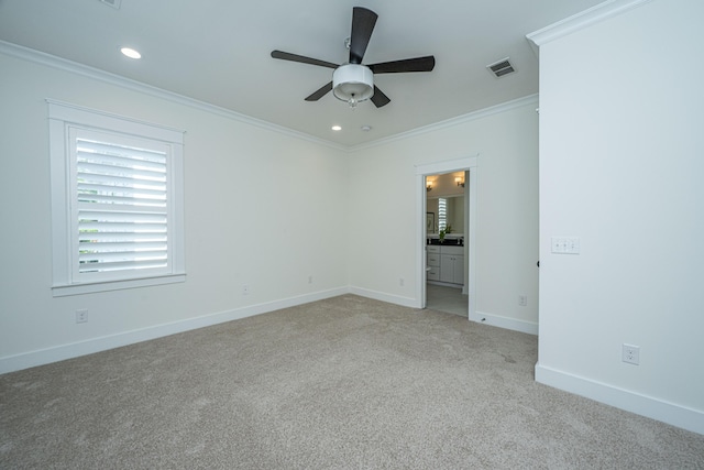 spare room with light carpet, ornamental molding, ceiling fan, baseboards, and recessed lighting