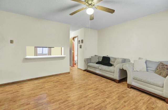 living room featuring ceiling fan and light hardwood / wood-style floors