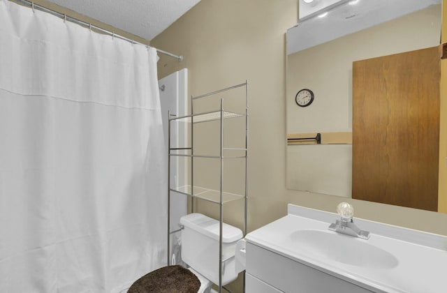 bathroom with vanity, a textured ceiling, toilet, and walk in shower