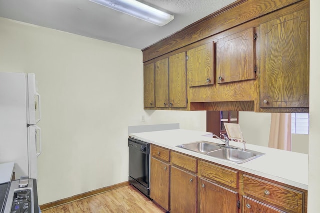 kitchen with sink, light hardwood / wood-style floors, dishwasher, and white fridge