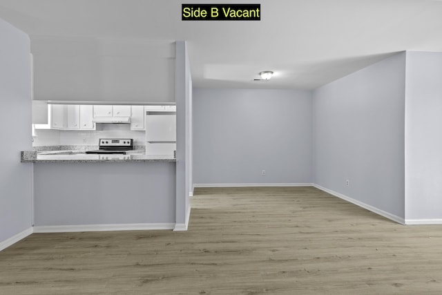 kitchen featuring stainless steel electric range oven, white built in fridge, under cabinet range hood, white cabinetry, and backsplash