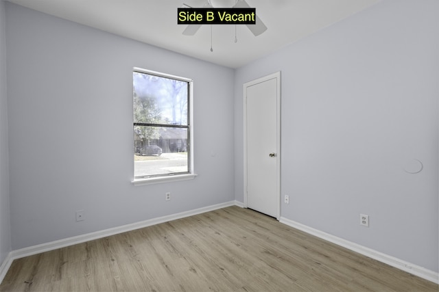 spare room with a ceiling fan, baseboards, and wood finished floors