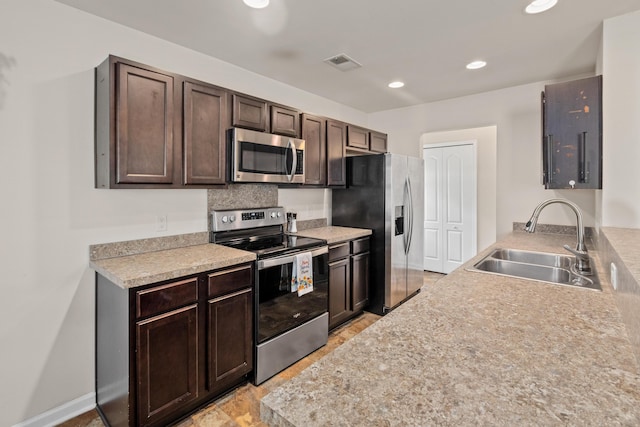 251 Coosawatchie St, Summerville, SC 29485 - kitchen with appliances with stainless steel finishes, a sink, dark brown cabinetry, light countertops, and recessed lighting