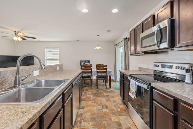 251 Coosawatchie St, Summerville, SC 29485 - kitchen featuring appliances with stainless steel finishes, a sink, healthy amount of natural light, light stone finish floors, and recessed lighting