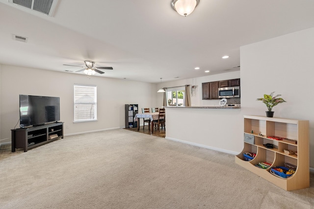 251 Coosawatchie St, Summerville, SC 29485 - living area with light carpet, a ceiling fan, recessed lighting, and baseboards