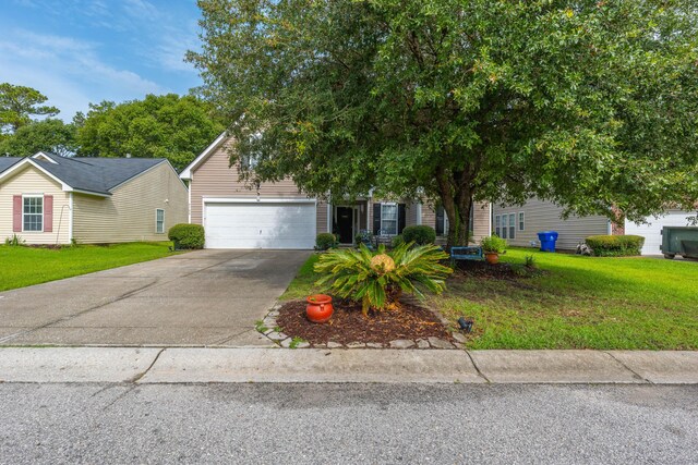 obstructed view of property with a garage and a front lawn