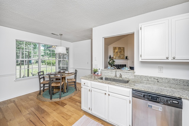 1918 Piper Dr, Charleston, SC 29407 - kitchen featuring dishwasher, a sink, light wood finished floors, white cabinets, and light stone countertops