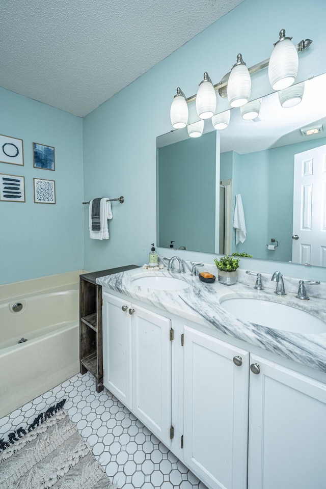 1918 Piper Dr, Charleston, SC 29407 - bathroom featuring double vanity, a bath, and a textured ceiling