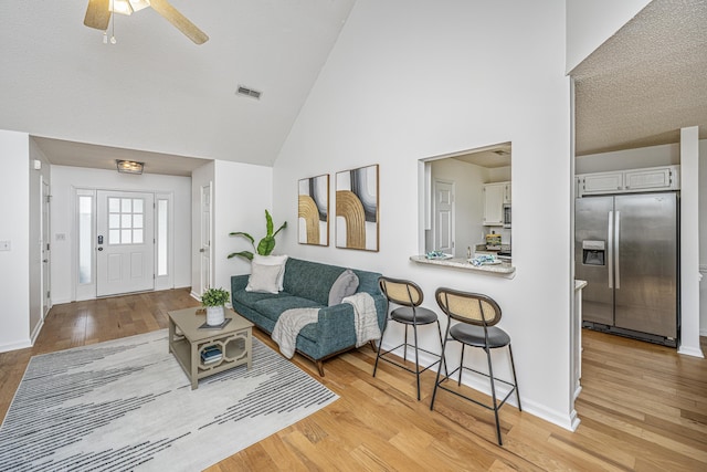 1918 Piper Dr, Charleston, SC 29407 - living area with high vaulted ceiling, baseboards, light wood finished floors, and a ceiling fan