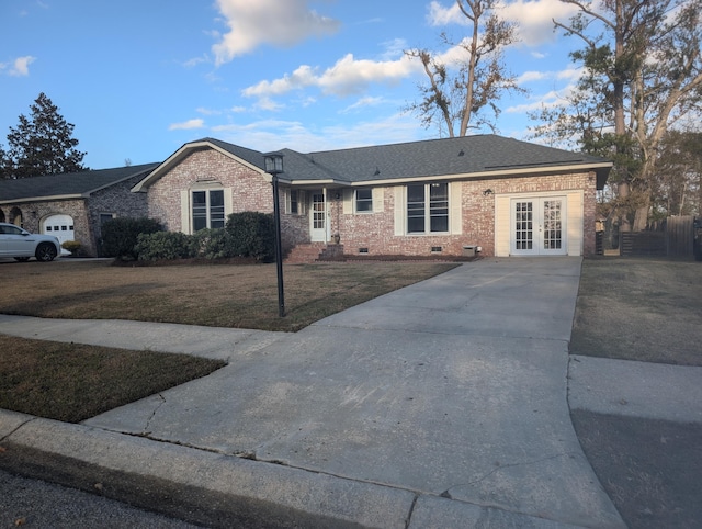 single story home with a front yard and french doors