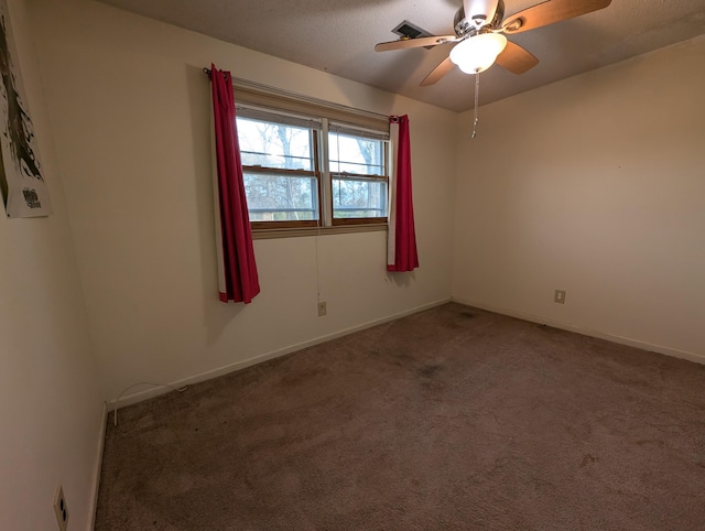 unfurnished room with ceiling fan and carpet