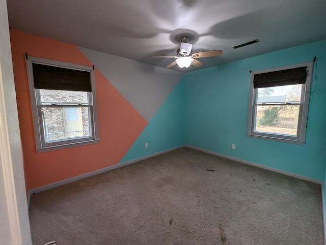 unfurnished room with ceiling fan and light carpet