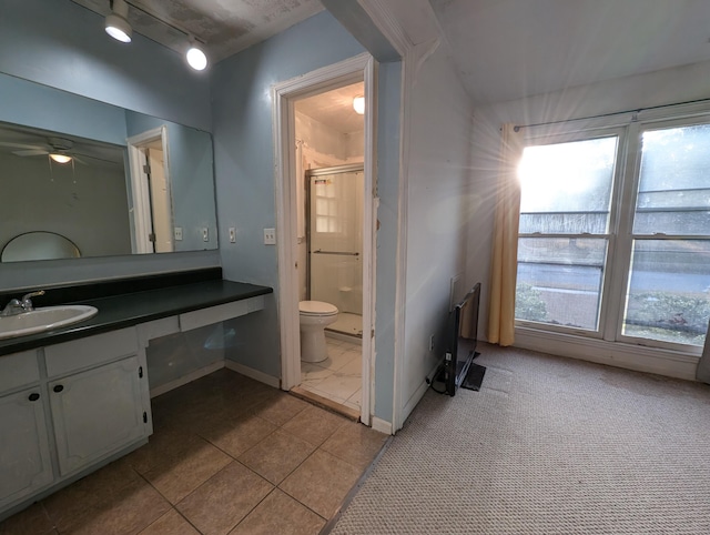 bathroom with ceiling fan, walk in shower, tile patterned floors, toilet, and vanity