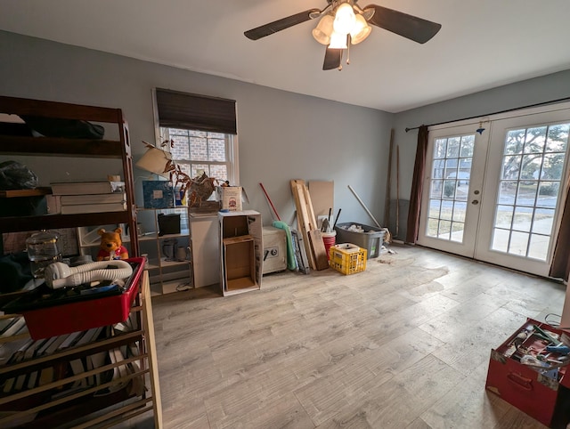 misc room with french doors, light hardwood / wood-style floors, plenty of natural light, and ceiling fan