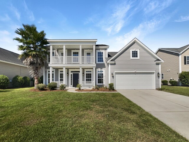 view of front of home with a balcony, a garage, a front yard, and covered porch