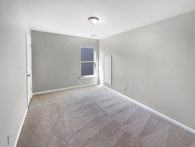 unfurnished room with light colored carpet