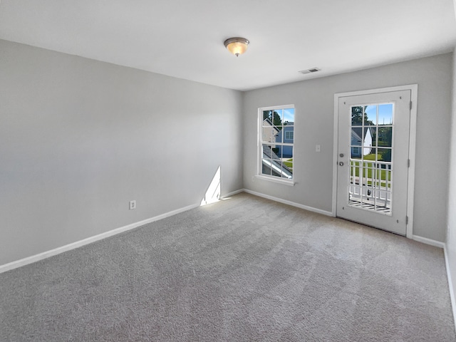 unfurnished room with light colored carpet