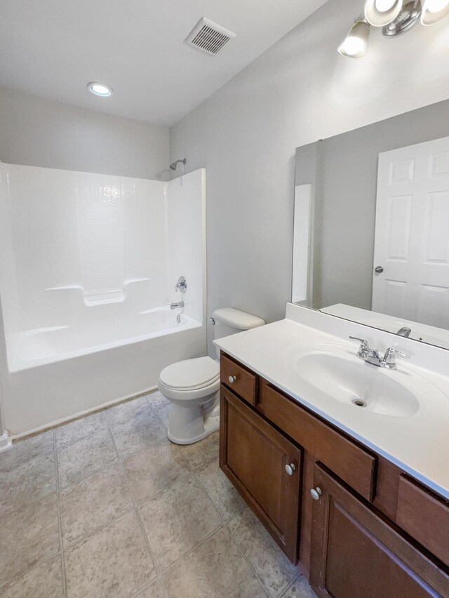 full bathroom with vanity, toilet, tile patterned flooring, and  shower combination