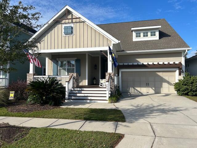 view of front of property with an attached garage, covered porch, concrete driveway, and board and batten siding