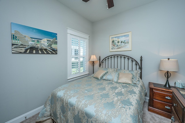 carpeted bedroom featuring baseboards and ceiling fan