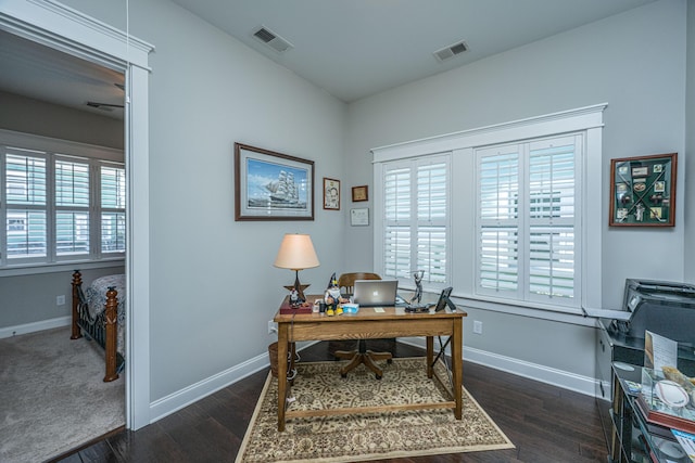 home office with dark wood-style flooring, baseboards, and visible vents