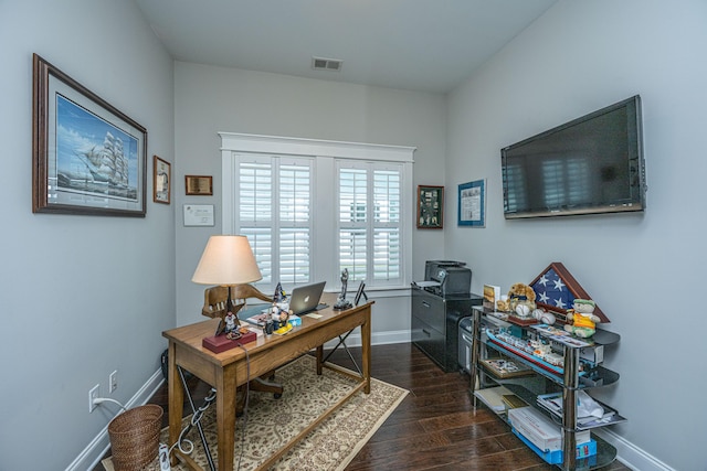 office area featuring wood finished floors, baseboards, and visible vents