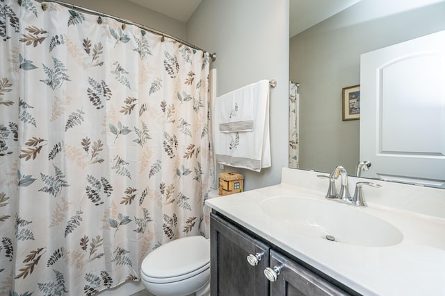 bathroom featuring toilet and vanity