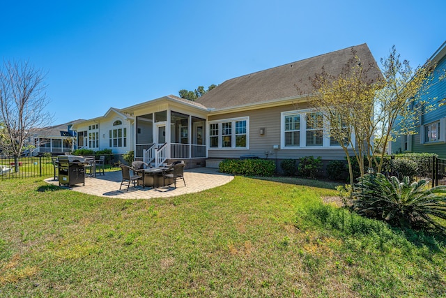 back of house with a yard, a sunroom, fence, and a patio area