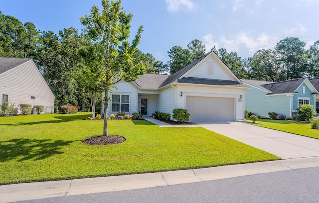 view of front of home with a front lawn and a garage