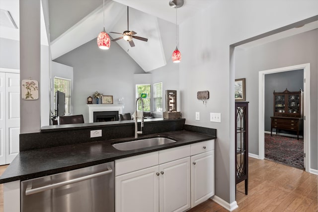 1431 Whispering Oak Trl, Mount Pleasant, SC 29466 - kitchen featuring dishwasher, dark countertops, light wood-style floors, open floor plan, and high vaulted ceiling