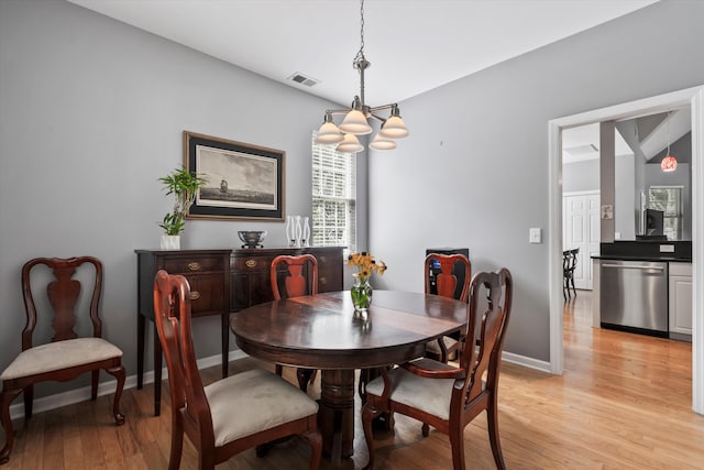 1431 Whispering Oak Trl, Mount Pleasant, SC 29466 - dining area with light wood-style flooring and a chandelier